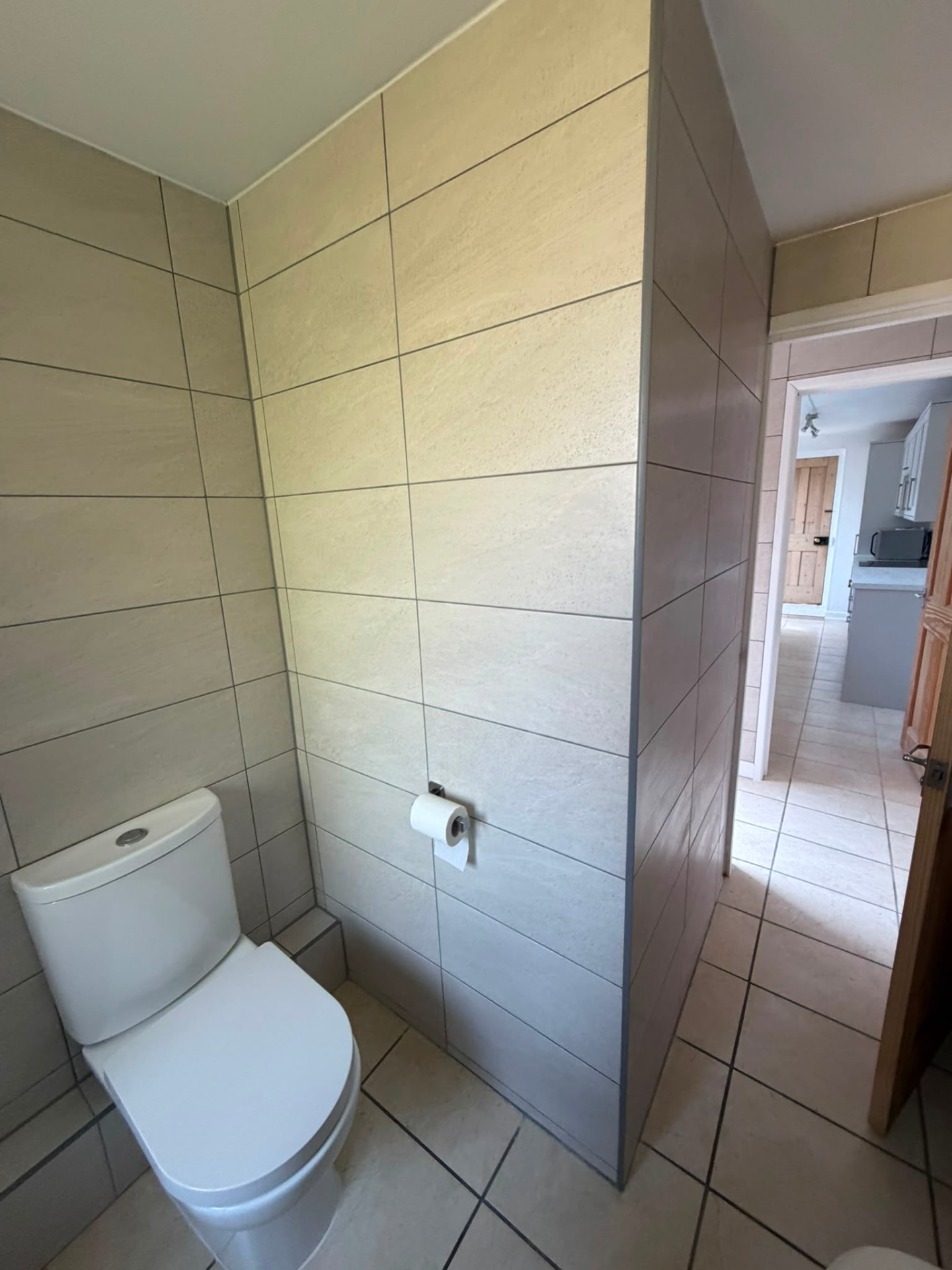 Finished white WC and tiled corner after renovation