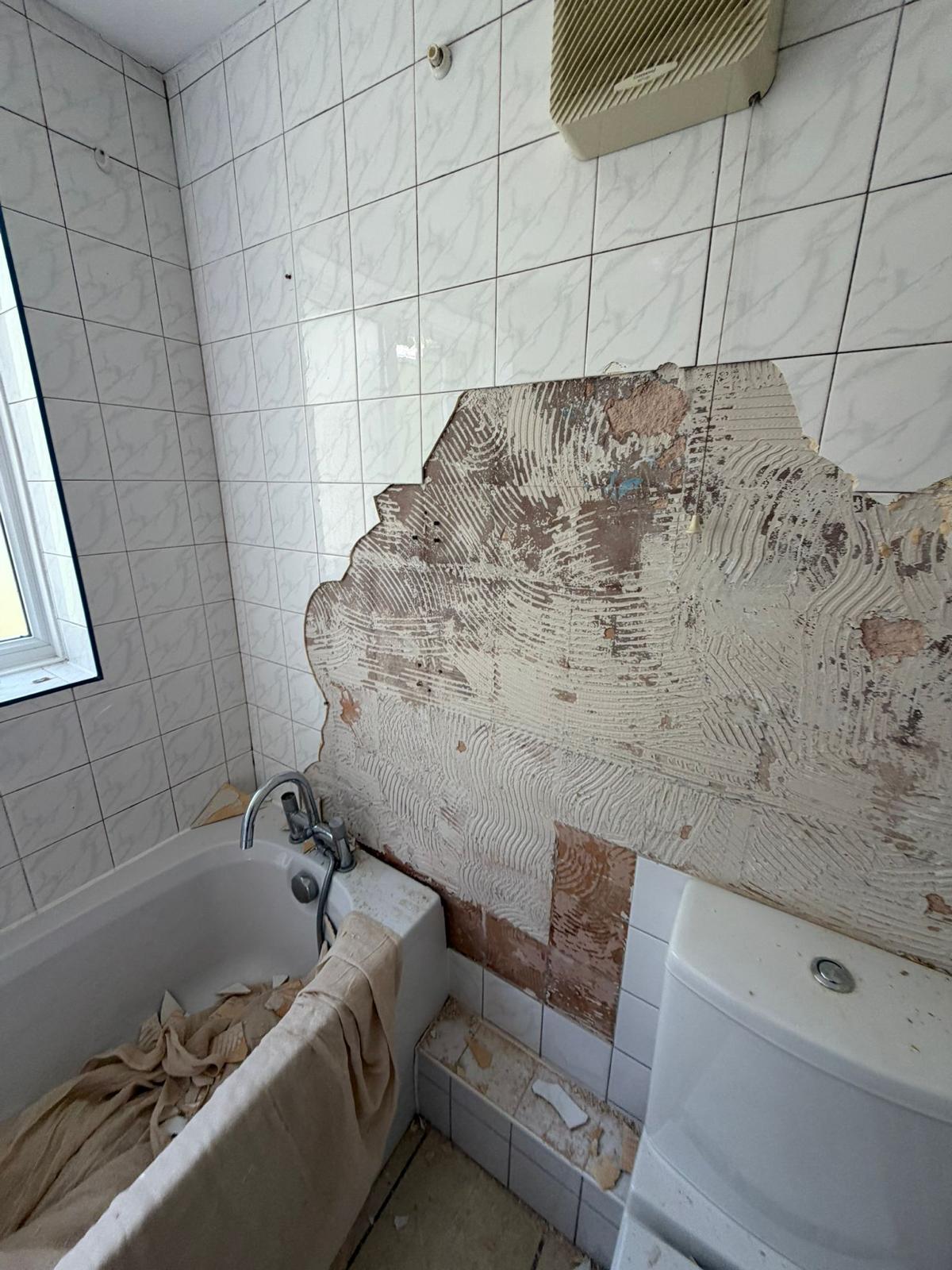 Bathroom stripped back to bare wall before refurbishment