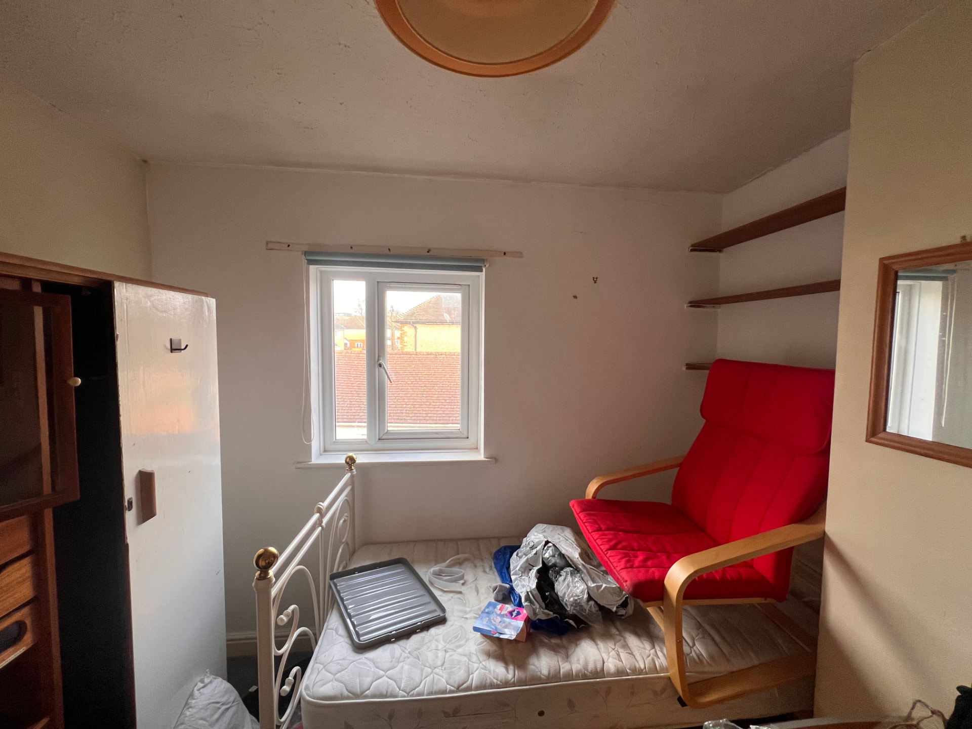 Small bedroom used for storage before renovation