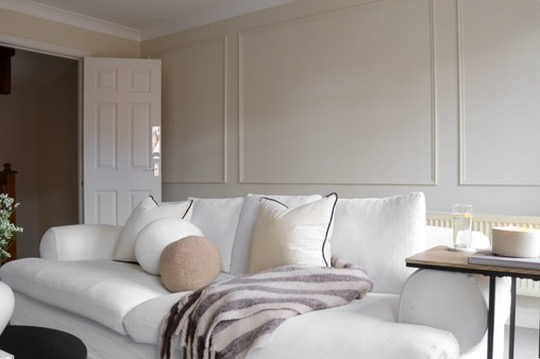 Bright living room with wall panelling and a deep sofa in a refurbished Oxfordshire home