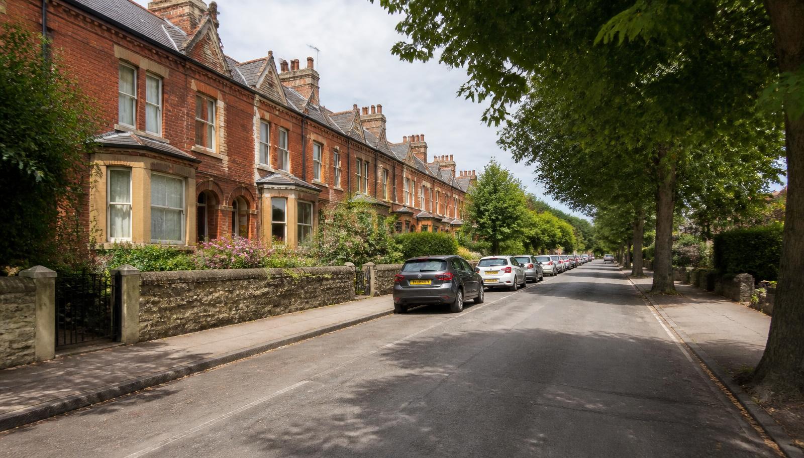 Victorian red-brick terraced houses on a leafy street in Headington, Oxford